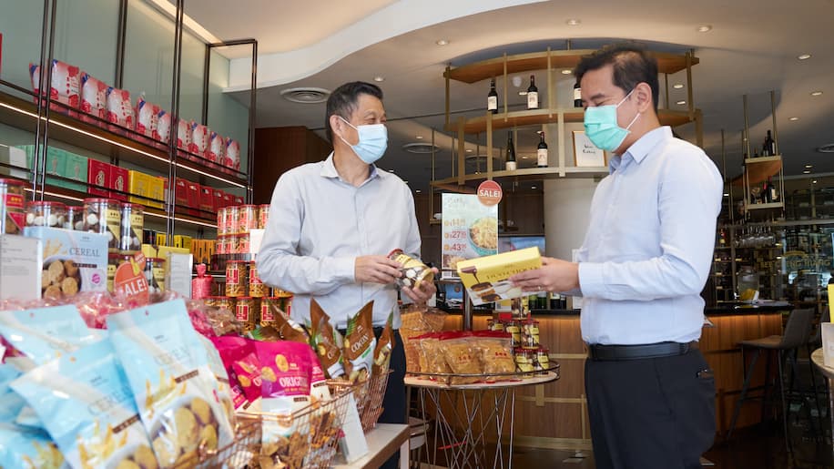 Two man checking on Bee Cheng Hiang's products