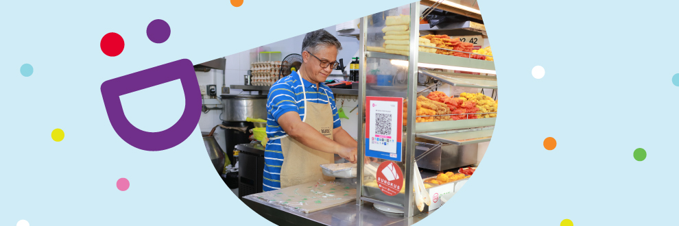 A stall owner has implemented QR codes to accept digital payments under the Hawkers Go Digital initiative