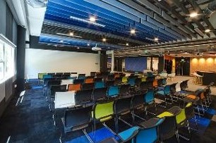 Event space with chairs set up for meetings at IMDA's PIXEL, showcasing the innovative space's adaptability