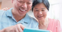 Elderly couple using phone - promoting media literacy and digital wellness in Singapore