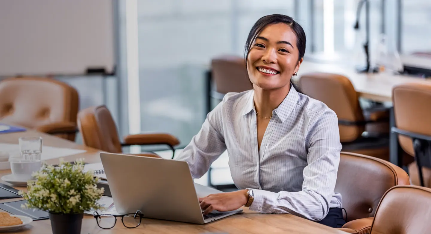Woman smiling while using her computer