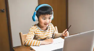 Boy wearing headset at an elearning course 