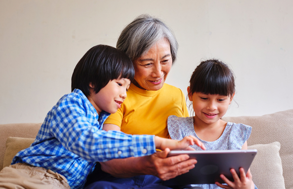Seniors Go Digital: A grandmother promotes digital literacy and digital wellbeing by reading to her grandchildren on a tablet device