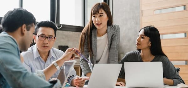 Diverse team plans successful strategy for new project on emerging technologies and digital transformation in small office.