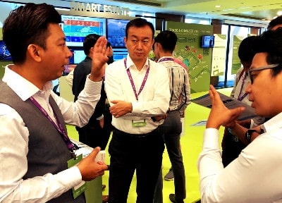 IMDA partners and attendees discussing digital solutions at the SG:D Industry Day exhibition in 2018