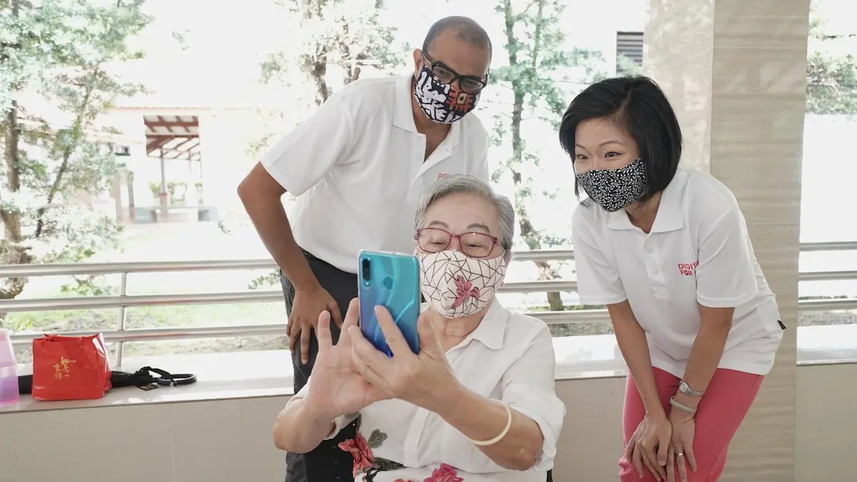 Digital for Life: A senior using her smartphone to take a group photo