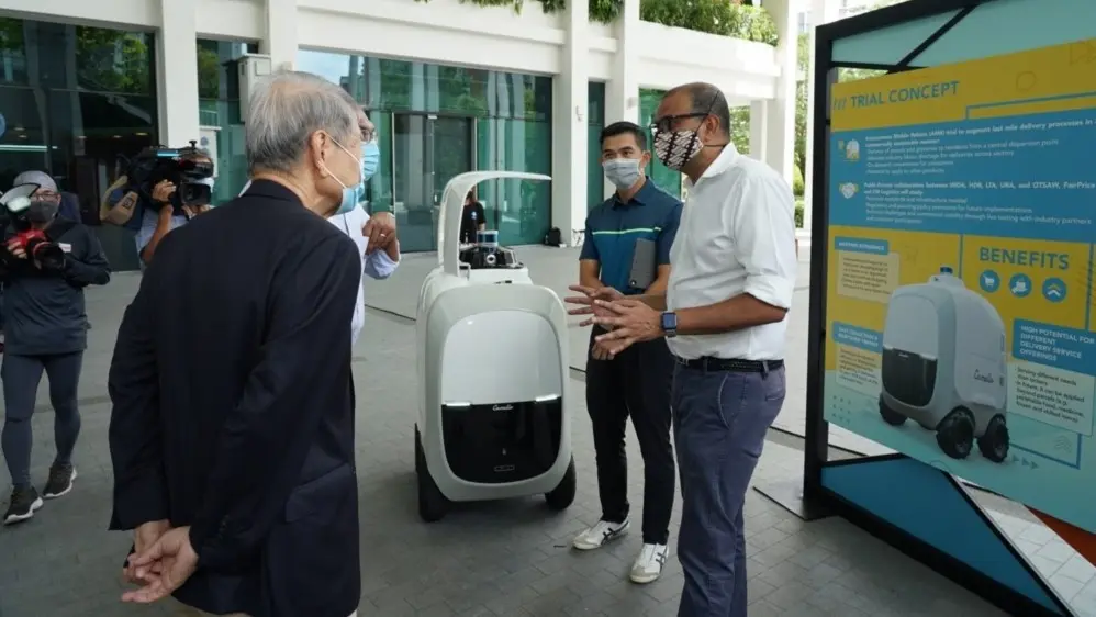 Dr Janil Puthucheary, along with IMDA representatives, introduced autonomous robots with AI technology in a trial to residents in Singapore