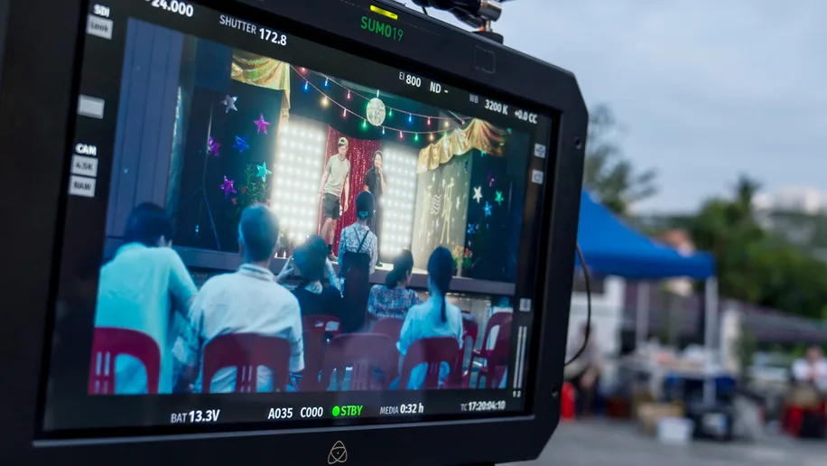 A shot from the camera monitor on the set of Wonderland, a Made with SG film, showing actors and producers preparing for a scene.