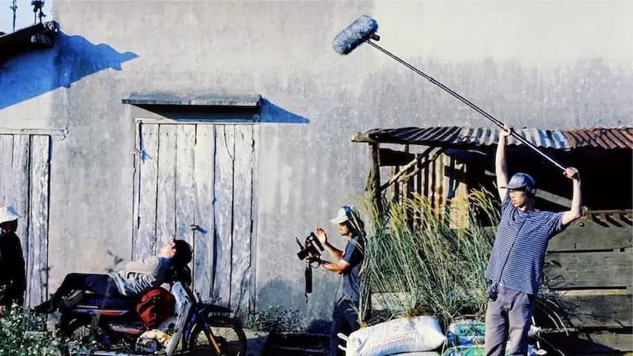 The film crew of Inside the Yellow Cocoon Shell, a Made with SG movie, at work on the set in a Vietnamese countryside, railway track, and river.