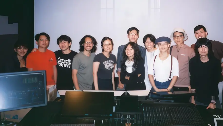 Audio director Xander and senior colourist and finishing artist Mark with the film production team in a recording studio.