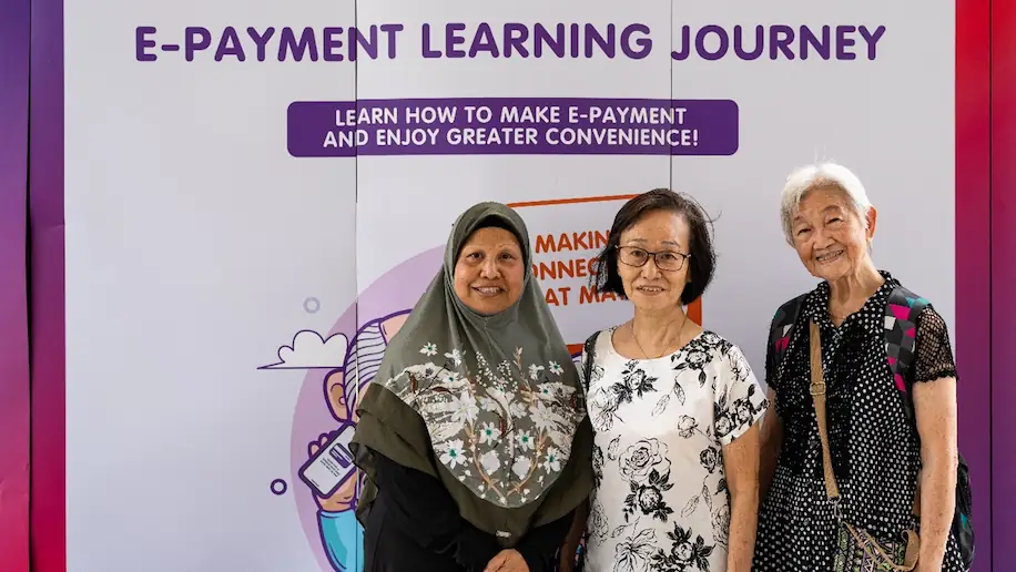 Madam Zainap poses with fellow attendees at a digital banking workshop aimed at enhancing customer experience.