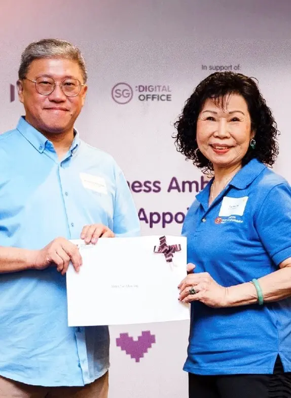 A photo of Madam Tan at her appointment as a Silver Infocomm Wellness Ambassador in 2022.