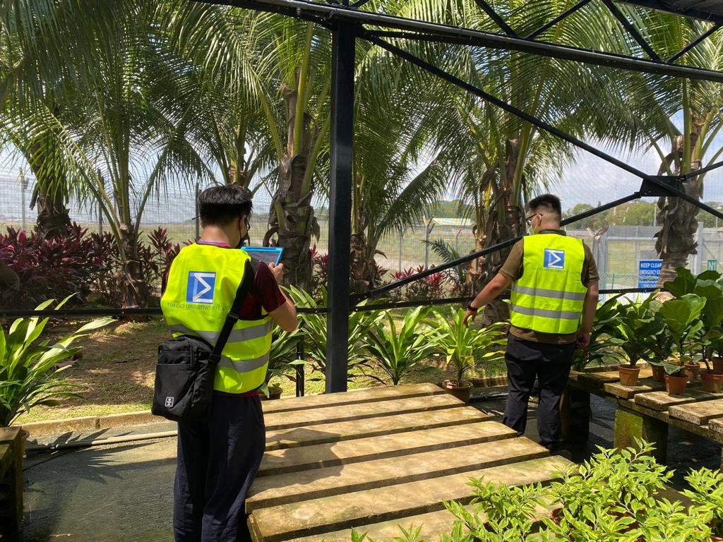 Two TSM employees conducting an outdoor inspection, highlighting the IMDA-accredited company's use of the Screening Eagle INSPECT app