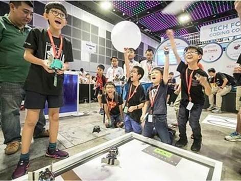 A group of young boys cheering for their teammate at the Zenitant's annual 3D-Tronics Competition, a Digital for Life Fund project