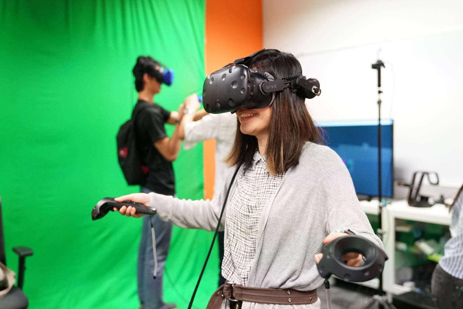 Woman in VR headset enjoying a game at IMDA's PIXEL AR/VR lab, highlighting Singapore's innovative technology space