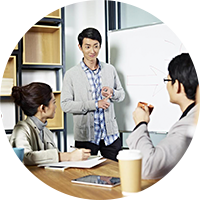 A group of professionals discussing in a meeting room as part of IMDA's IMTalent cybersecurity training programmes and courses