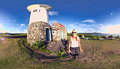 A woman posing for a photo at a tourist spot representing iMMERSiVELY, one of the featured immersive media companies in Singapore