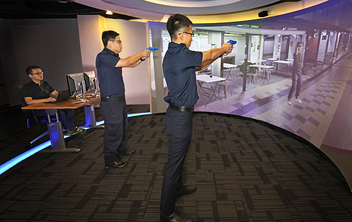 VR-powered simulations by ST Electronics: Two officers training in a virtual reality environment to handle public safety incidents