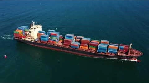 An image showing a massive container ship sails across the vast ocean, transporting goods and connecting distant shores.