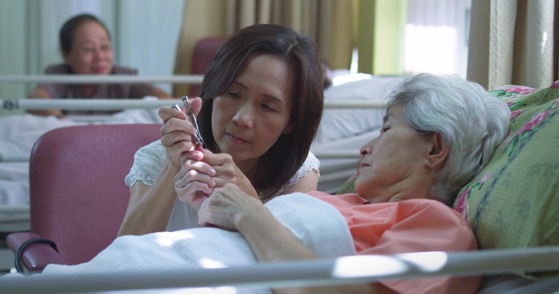 A scene from the Singaporean film 'Sandcastle' showing characters in a contemplative moment, highlighting the film's emotional depth.