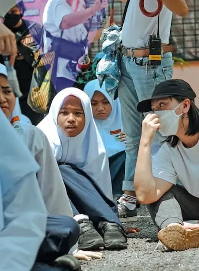 Amanda Nell Eu with the cast and crew of Tiger Stripes, a Made with SG movie, on set in a Malaysian school.