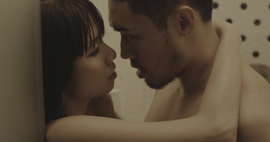 Intimate scene from Lang Tong film showing close-up of couple in emotional moment, highlighting the movie's intense themes.